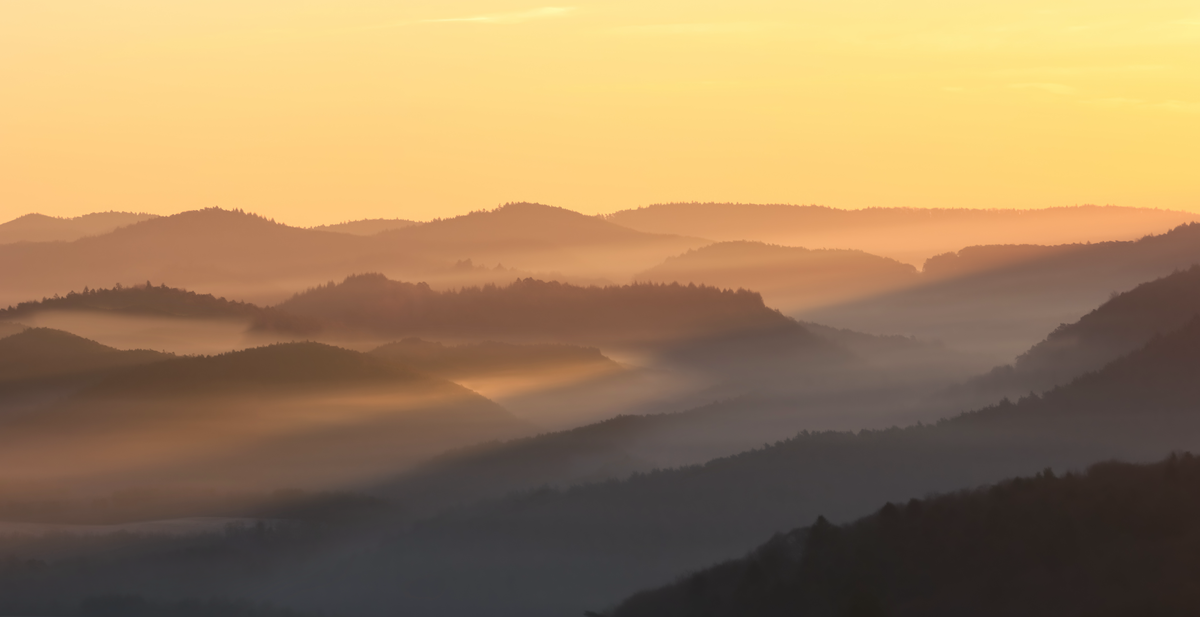 Layered mountain silhouettes during a sunset